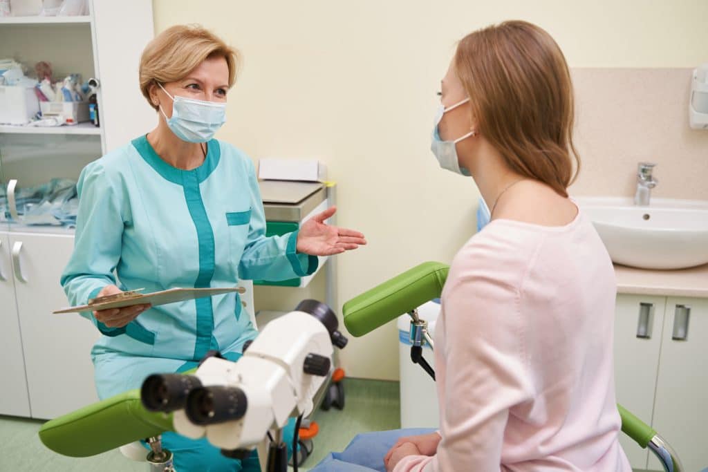 Emotional female doctor talking to her patient