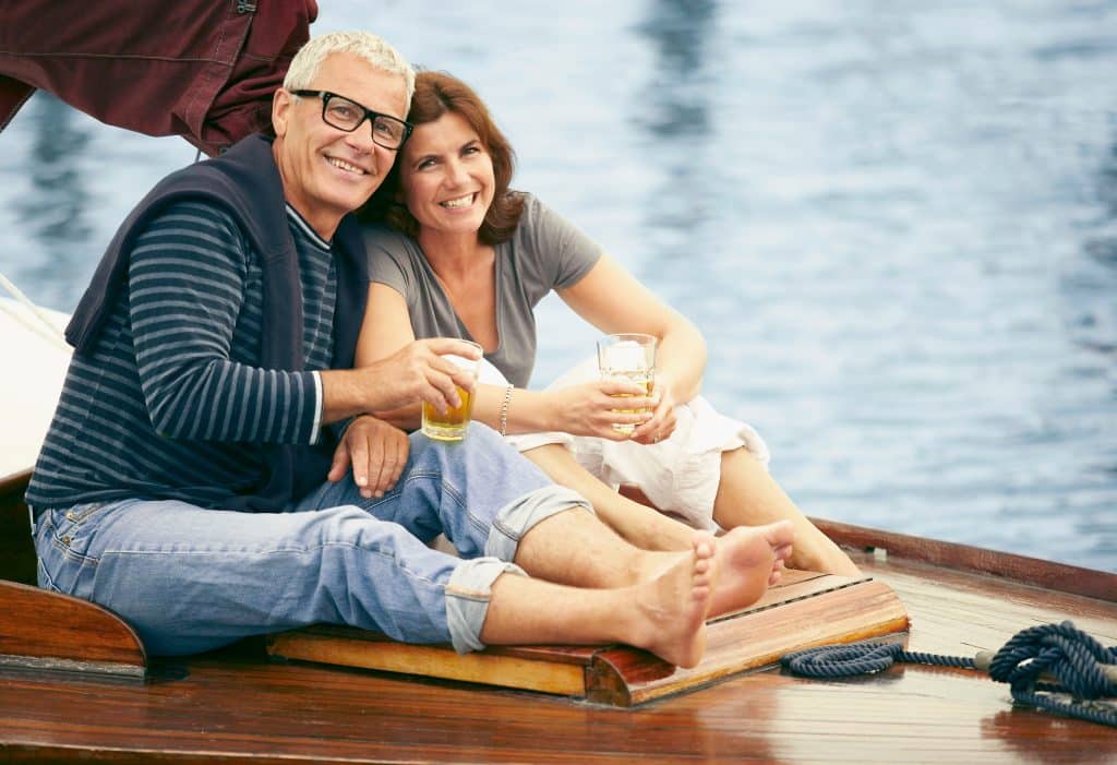 Middle aged couple drinking on boat