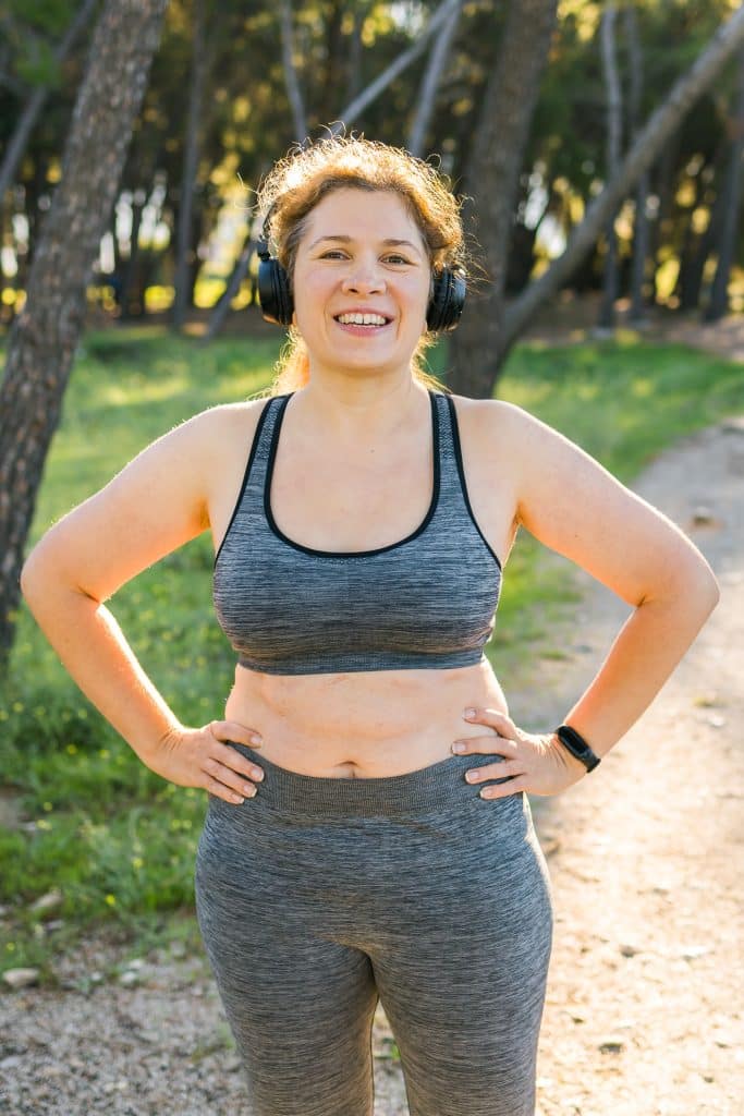 Fat body positivity woman and sports. Girl doing exercise for weight loss in the fresh air and