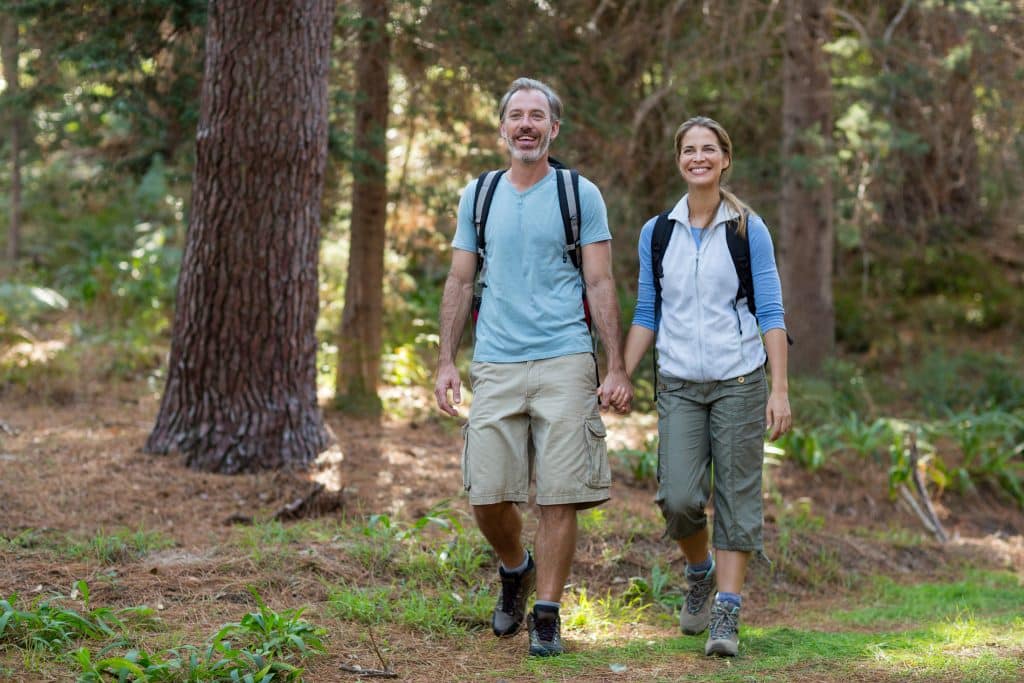 Hiker couple hiking in forest